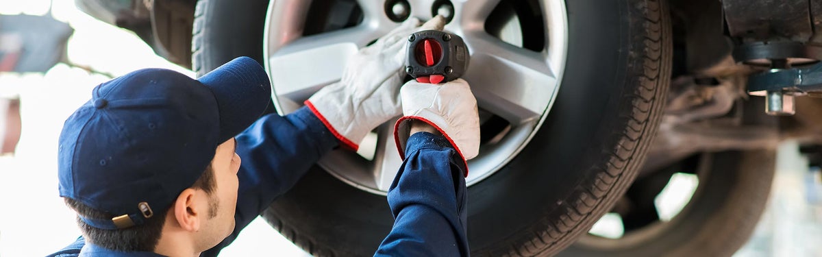 Mechanic removing a wheel from a car